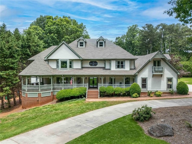 5102 Chastleton Dr, Stone Mountain, GA 30087 - view of front of home with covered porch, roof with shingles, and a front lawn