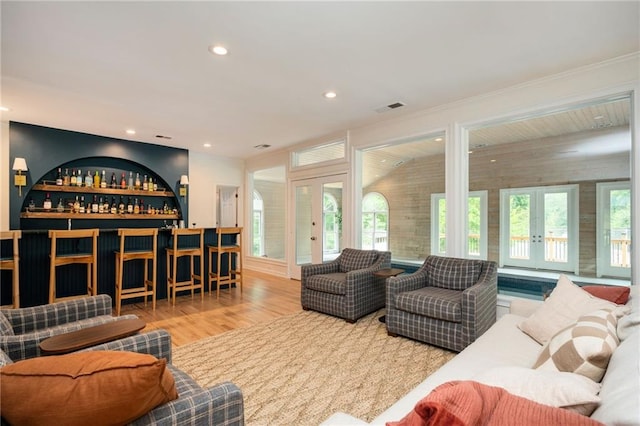 5102 Chastleton Dr, Stone Mountain, GA 30087 - living room featuring french doors, a bar, wood finished floors, and recessed lighting