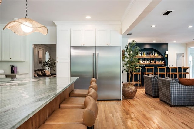 5102 Chastleton Dr, Stone Mountain, GA 30087 - kitchen featuring built in refrigerator, open floor plan, light stone countertops, light wood-style floors, and recessed lighting