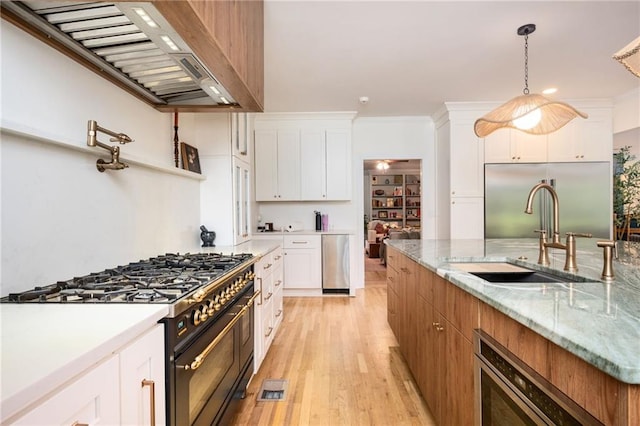 5102 Chastleton Dr, Stone Mountain, GA 30087 - kitchen with high quality appliances, a sink, custom exhaust hood, and white cabinets