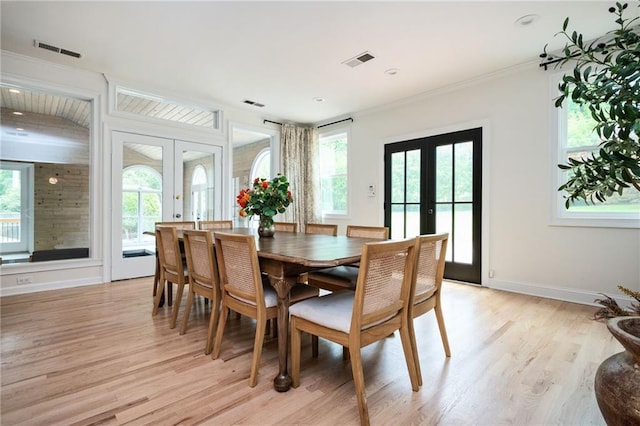 5102 Chastleton Dr, Stone Mountain, GA 30087 - dining room with french doors, light wood finished floors, crown molding, and baseboards