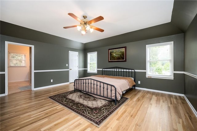 5102 Chastleton Dr, Stone Mountain, GA 30087 - bedroom featuring wood finished floors, multiple windows, baseboards, and vaulted ceiling