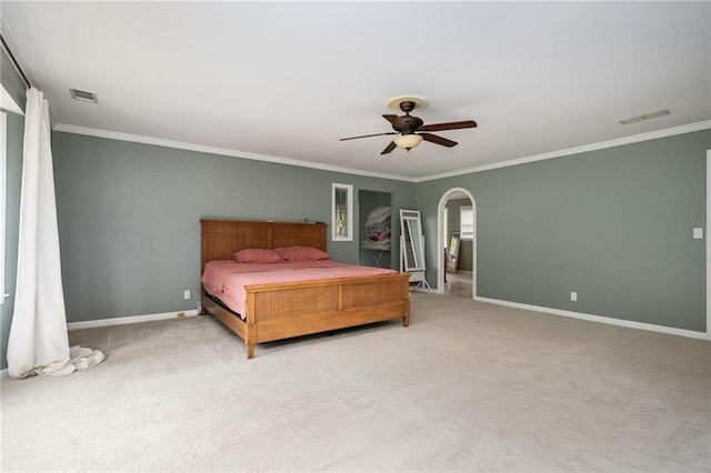 5102 Chastleton Dr, Stone Mountain, GA 30087 - carpeted bedroom with ornamental molding, baseboards, ceiling fan, and arched walkways