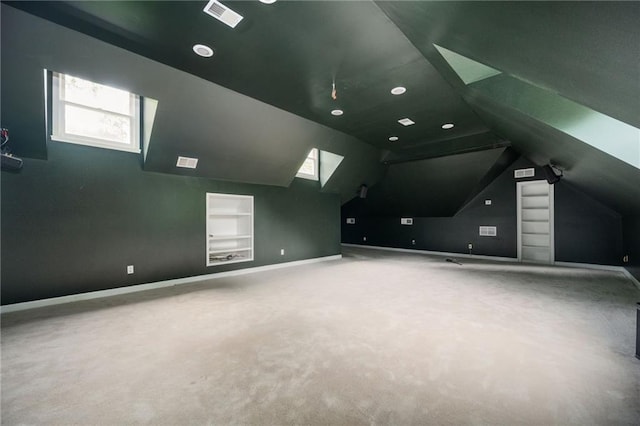 5102 Chastleton Dr, Stone Mountain, GA 30087 - additional living space featuring built in shelves, carpet, vaulted ceiling, baseboards, and recessed lighting