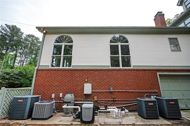 5102 Chastleton Dr, Stone Mountain, GA 30087 - view of property exterior with central AC, brick siding, and an attached garage