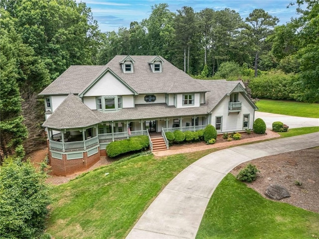 5102 Chastleton Dr, Stone Mountain, GA 30087 - view of front facade with a porch, a shingled roof, a front yard, and driveway
