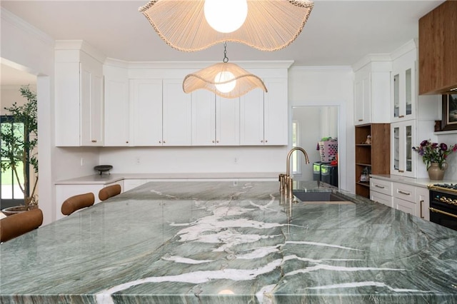 5102 Chastleton Dr, Stone Mountain, GA 30087 - kitchen with a sink, white cabinets, glass insert cabinets, and crown molding