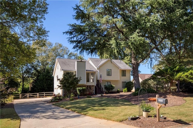 raised ranch featuring a front yard