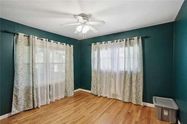 spare room featuring wood-type flooring and ceiling fan