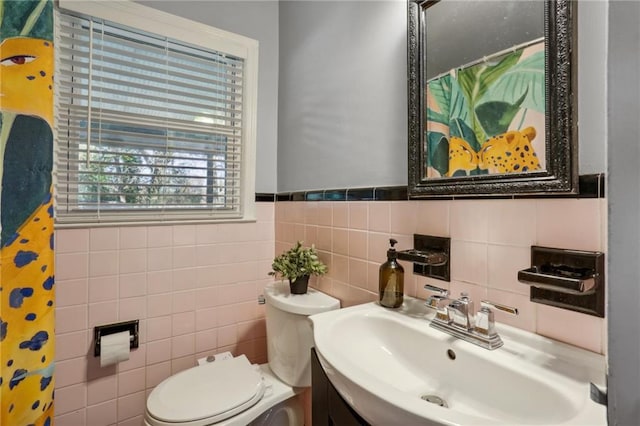 bathroom featuring toilet, vanity, tile walls, and walk in shower