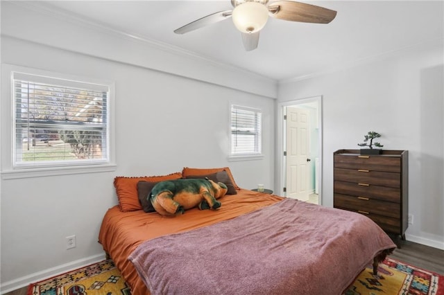 bedroom featuring ceiling fan, ornamental molding, and wood-type flooring