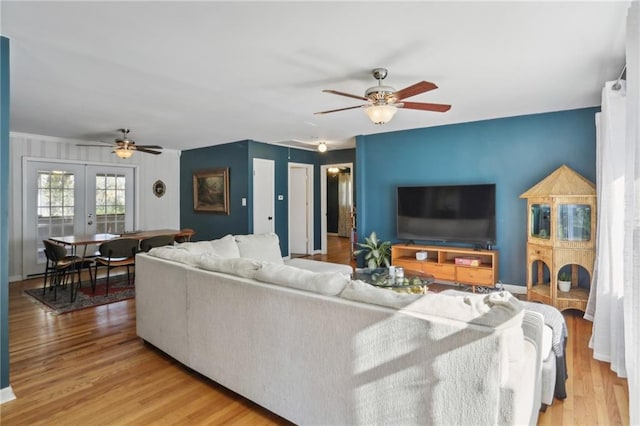 living room featuring light hardwood / wood-style floors and french doors