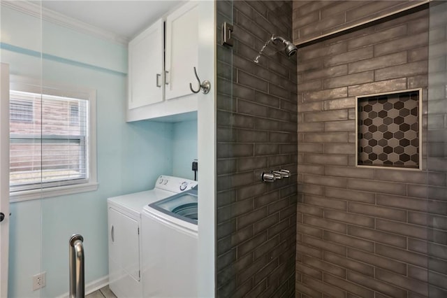 laundry area with washer and dryer, cabinets, and ornamental molding