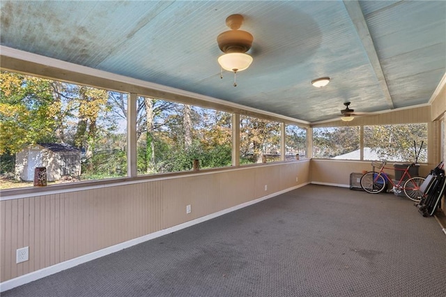 unfurnished sunroom featuring ceiling fan