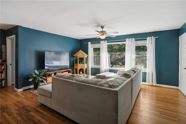 living room featuring wood-type flooring and ceiling fan