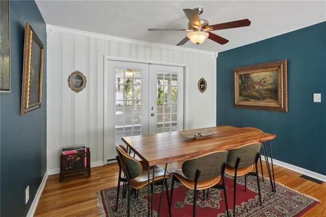 dining area with french doors, wood-type flooring, and ceiling fan