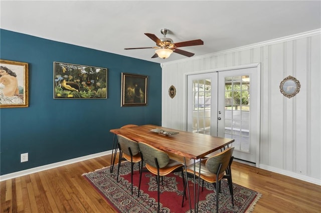 dining room with ceiling fan, french doors, and wood-type flooring