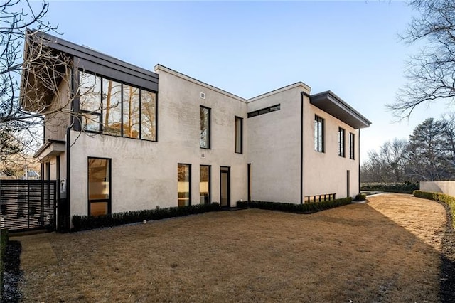 back of house featuring stucco siding