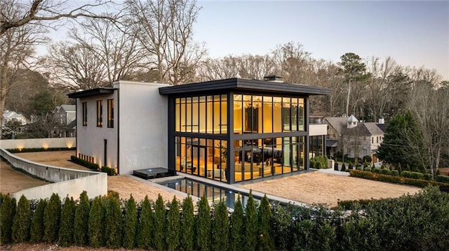 rear view of property featuring fence