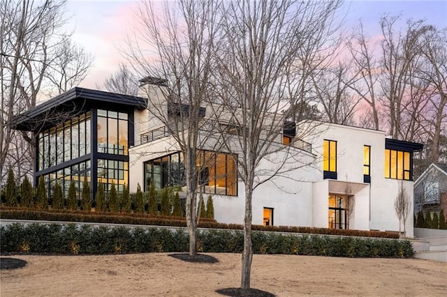 exterior space with stucco siding and a chimney