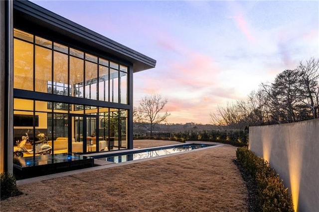 exterior space featuring a patio, fence, and an outdoor pool