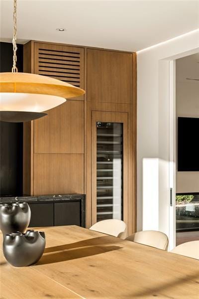 interior space with wood counters, wine cooler, modern cabinets, and brown cabinetry