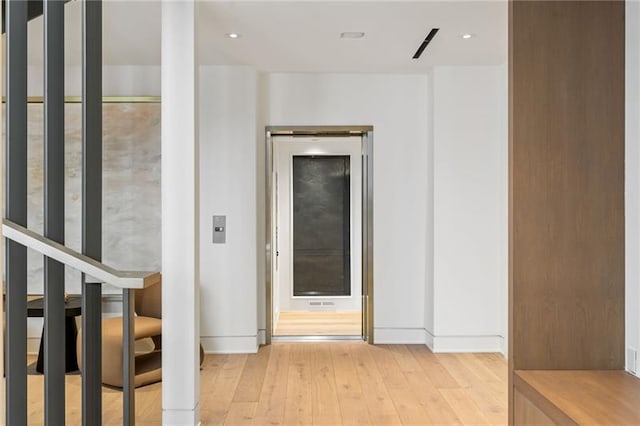 hall featuring recessed lighting and light wood-style flooring