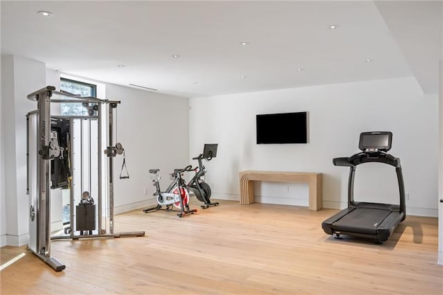 workout area with light wood-style flooring, recessed lighting, and baseboards