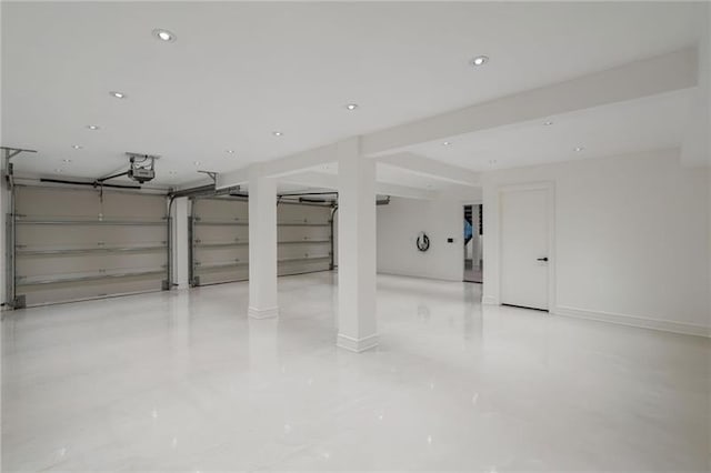 garage with recessed lighting, a garage door opener, and baseboards