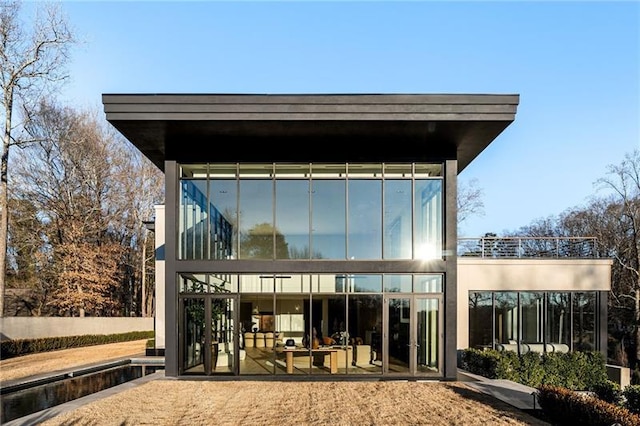 rear view of house with a balcony and a patio area