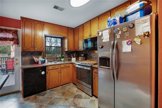 kitchen featuring sink, black appliances, and backsplash