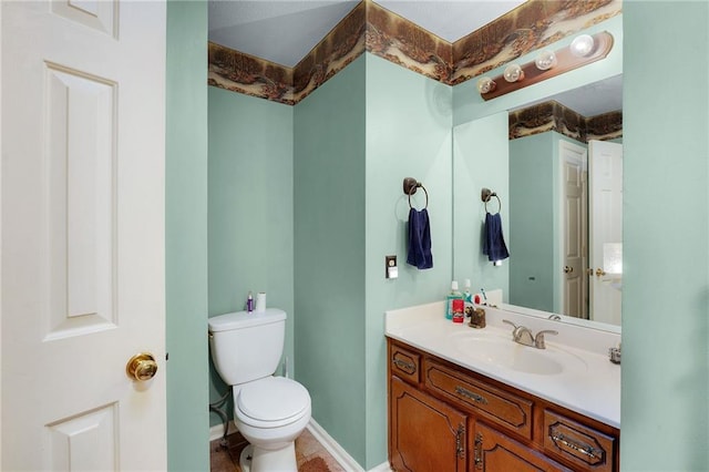 bathroom featuring toilet and vanity