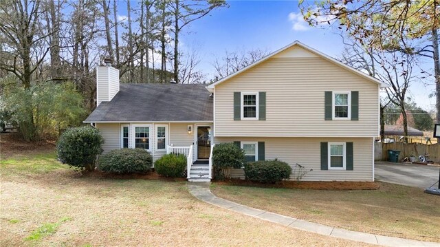 split level home featuring a front lawn