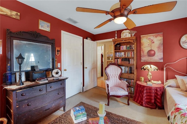 sitting room featuring light carpet and ceiling fan