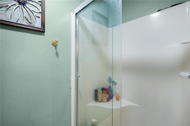 bathroom with a shower with door