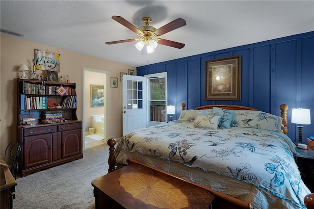 bedroom with connected bathroom, light colored carpet, and ceiling fan