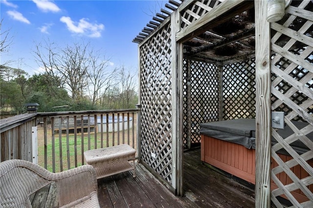 wooden deck featuring a hot tub