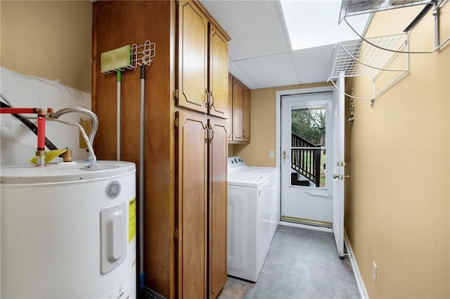 laundry room featuring cabinets, independent washer and dryer, and electric water heater