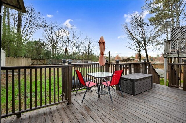 wooden deck with a lawn