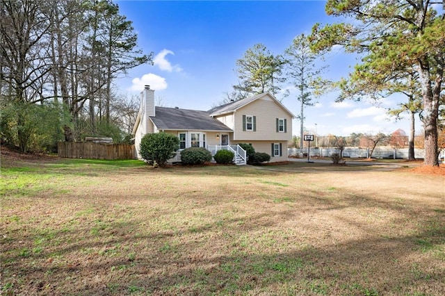 rear view of property with a lawn