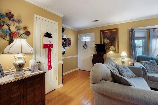 living room featuring light hardwood / wood-style floors and crown molding