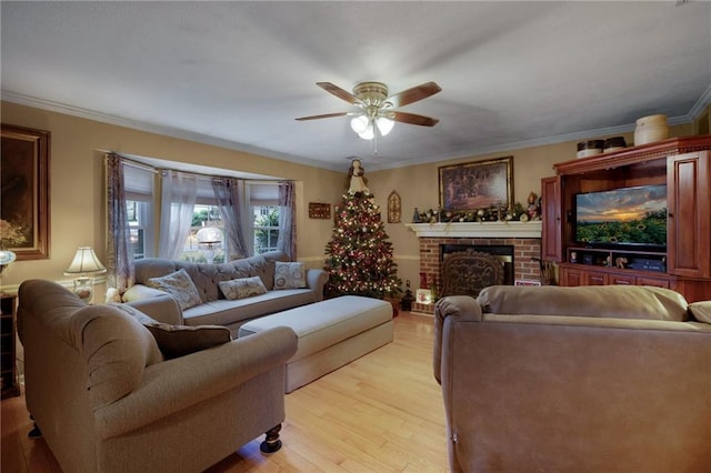 living room featuring ornamental molding, a brick fireplace, and light hardwood / wood-style flooring