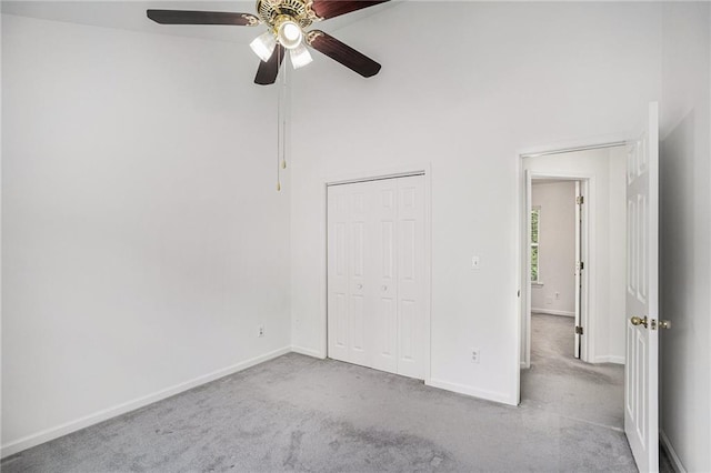 2949 Maple Walk Ct, Lawrenceville, GA 30044 - unfurnished bedroom featuring a closet, a high ceiling, ceiling fan, and light colored carpet
