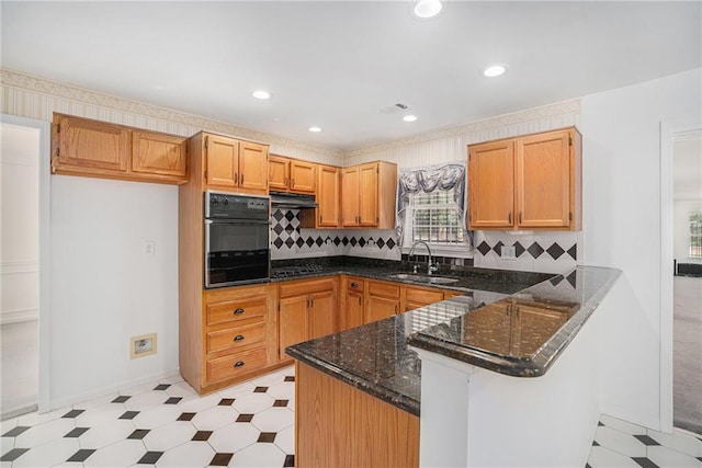 2949 Maple Walk Ct, Lawrenceville, GA 30044 - kitchen featuring sink, kitchen peninsula, backsplash, light colored carpet, and black oven