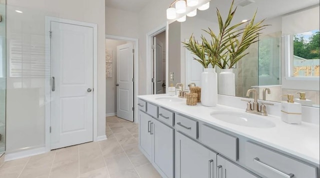 bathroom with vanity, tile patterned floors, and a shower with door