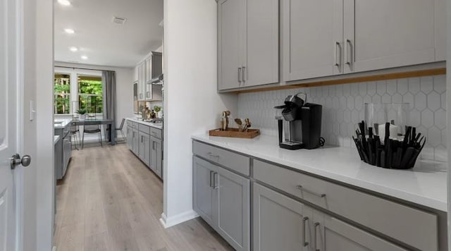 1346 Auburn Glen Rd, Dacula, GA 30019 - kitchen featuring gray cabinets, light wood-style floors, backsplash, light countertops, and recessed lighting
