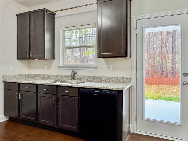 kitchen with a sink, black dishwasher, dark brown cabinetry, light stone countertops, and dark wood-style flooring