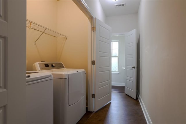 laundry area with washer and dryer, dark wood-style floors, visible vents, and baseboards