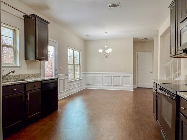 kitchen featuring black appliances, dark brown cabinets, visible vents, and a sink