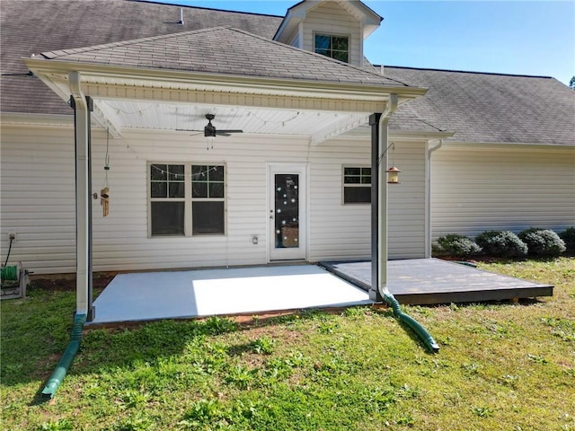 back of house with a patio area, a lawn, a shingled roof, and ceiling fan